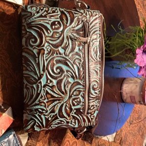 A beautiful teal/brown leather Patricia Nash handbag with shoulder strap